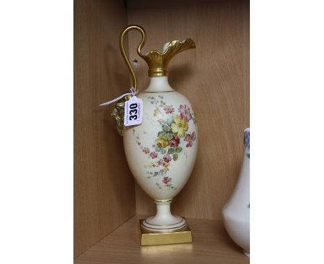 A ROYAL WORCESTER BLUSH IVORY EWER, florally decorated, with moulded mask (nose rubbed) to the handle and raised on pedestal 