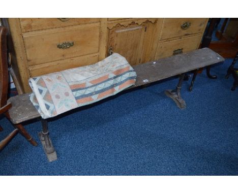 AN EARLY 20TH CENTURY PINE RAILWAY BENCH, on cast iron frame, marked Hawes, approximate length 164cm