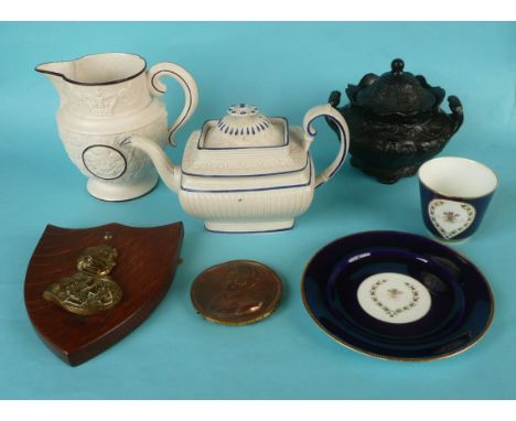 A white moulded stoneware jug, 155mm, cracked, a similar teapot and cover, a moulded black pottery sucrier and cover, chipped