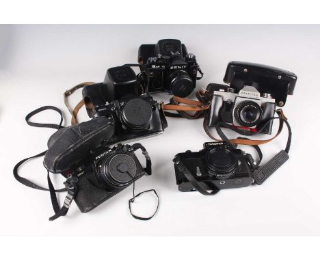 A collection of assorted cameras and lenses, including a Pentax MV camera with 1:1.7 50mm lens, an Olympus OM40 Program camer