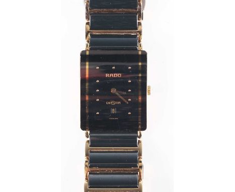 A Rado Diastar gilt metal and black ceramic bracelet wristwatch with quartz movement, the signed rectangular dial with gilt d