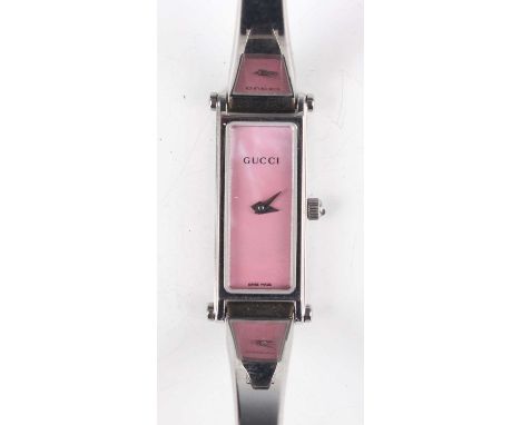 A Gucci 1500 L stainless steel lady's bangle wristwatch with signed mother-of-pearl rectangular dial, the case back detailed 