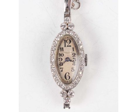 An Audemars Piguet &amp; Co Geneve platinum and diamond set oval lady's bracelet dress watch, the signed and jewelled movemen