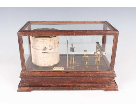 An early 20th century oak barograph with gilt lacquered mechanism and clockwork recording drum, with applied plaque inscribed