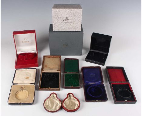 An Omega red watch case, the underside numbered '5501', together with a collection of other watch cases and boxes, including 