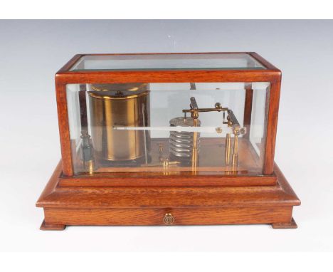 An early 20th century oak cased barograph with gilt lacquered brass mechanism and clockwork recording drum, all beneath a bev