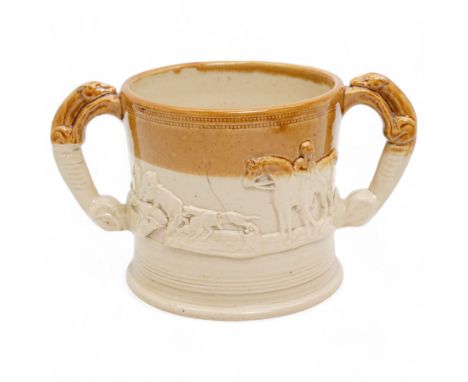 18th century twin-handled tankard, the handles formed as two greyhounds, decorated in relief with hunting and farming scenes,