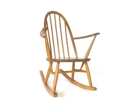 An Ercol elm and beech rocking chair   CONDITION REPORT:  Structurally sound but worn