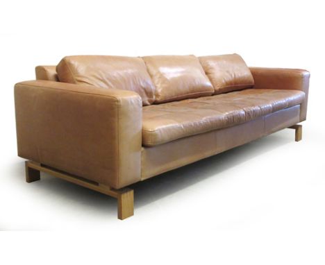 A Danish tan leather three seater sofa on an oak frame