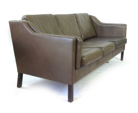 A Danish brown leather three seater sofa on mahogany square feet