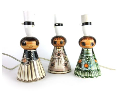 A set of three Jersey Pottery table lamp bases in the form of young ladies, h. 13 cm
