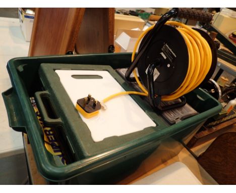 Box containing work light toolbox extension reel etc