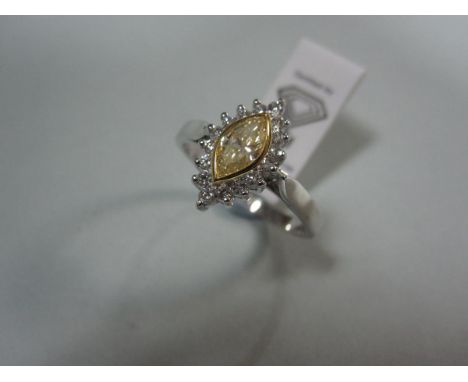 A certificated marquise cut yellow diamond and diamond cluster ring, the fancy light yellow marquise cut diamond in a yellow 
