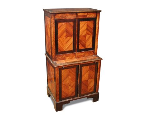 A small 19th century continental kingwood cabinet, crossbanded in rosewood, the upper half fitted small drawers and central o