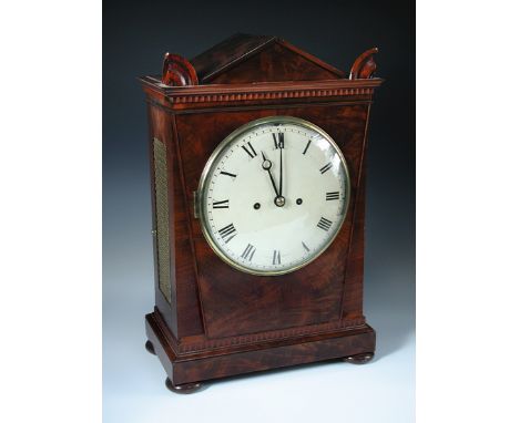 A Regency mahogany bracket clock, the Egyptian style case with arched pediment and enamel dial, twin fusee movement, unsigned