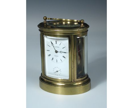 A French oval brass carriage clock with alarm and repeat, shaped handle above rectangular enamel dial signed 'Wm Jaffray, Gla