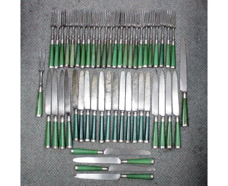 Twelve steel bladed table knives, with green stained bone handles with unmarked silver ferrules and end caps, crested, 28cmtw