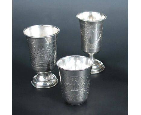 Three Russian silver vodka cups, comprising a small beaker Moscow 1882, by Israel Eseevich Zakhoder, assay master A.K, 5cm, f
