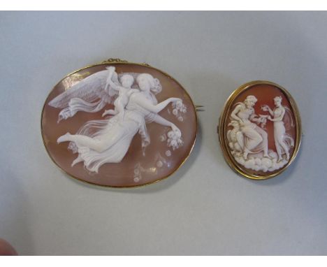 Two shell cameo brooches depicting classical gods, the first depicting Eos, winged goddess of the dawn, scattering roses from