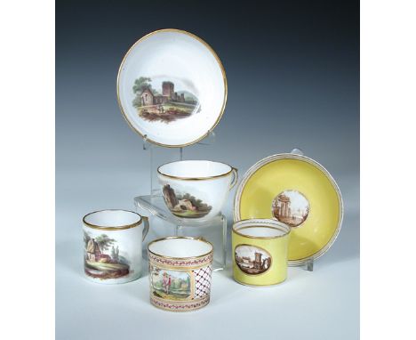A Coalport trio, a can and saucer and a single can, the first painted with ruins in a landscape, the second of yellow ground 