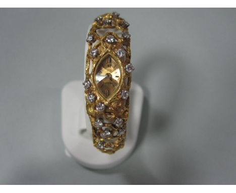 An Omega 18ct gold and diamond lady's evening watch, the navette shaped face of brushed gold with baton hour markers and face