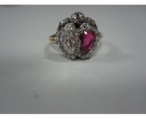A ruby and diamond double heart ring, the principal old pear cut diamond and similarly cut ruby in interlocked heart shaped b