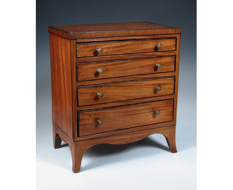An early 19th century satinwood miniature chest of drawers, the four graduated crossbanded drawers raised on splayed bracket 