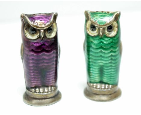 A pair of Norwegian metalwares pepper casters, each modelled as an owl, one with green enamel decorated plumage, the other wi