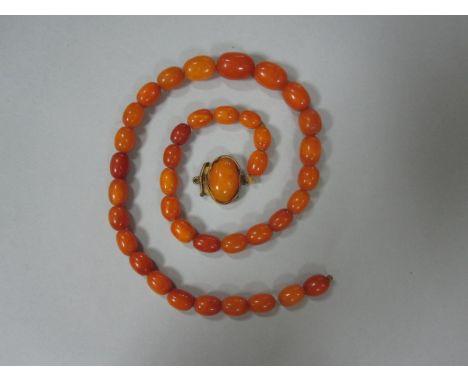A vintage butterscotch amber bead necklace, the graduated oval beads of opaque amber from 11-17mm long, slightly variable in 