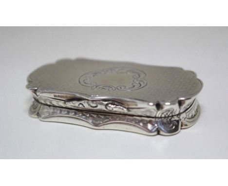 A large Victorian silver vinaigrette by Alfred Taylor, Birmingham 1853, of serpentine form, engine turned with engraved folia
