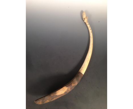 A 19th century ivory and snakeskin harp, possibly Luba or Mangetu, a stylised head carved above the five string holes to the 