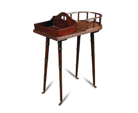 A mahogany plate Canterbury, 19th century with spindle gallery end and flatware tray and carrying handle, on slender ring tur