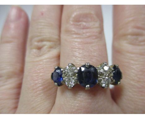 A sapphire and diamond seven stone ring, the three graduated oval cut sapphires separated by pairs of round brilliant cut dia