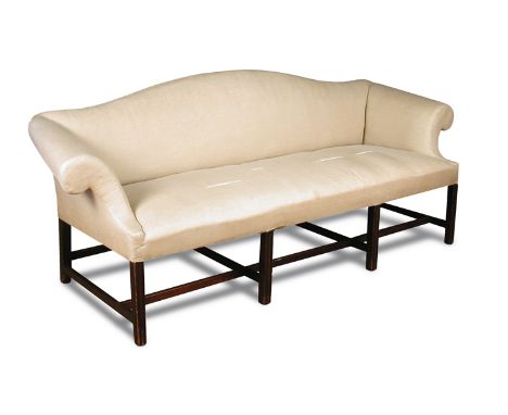 A George III mahogany framed sofa, with outswept scrolling arms, upholstered in a cotton fabric, on stretchered moulded squar