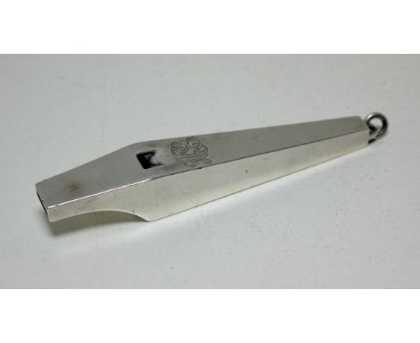 A streamlined modern silver whistle by Garrard & Co Ltd, London 1990, the plain body of square tapering form with suspension 
