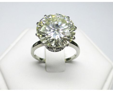 A certificated 5.76ct diamond single stone ring, the round brilliant cut diamond currently multi-claw set above a smaller cir