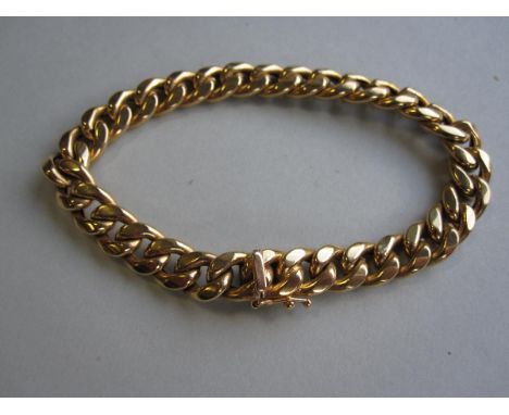 An Italian 18ct gold curb link bracelet by Unoaerre, the flattened polished links to a masked clasp with safety catch, with I