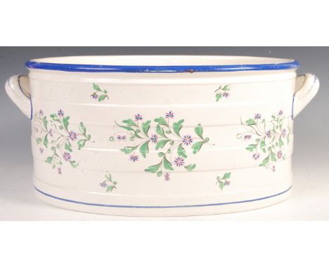An antique 19th century Victorian Copeland Spode made ceramic footbath. Decorated with florals to the body, with a blue paint