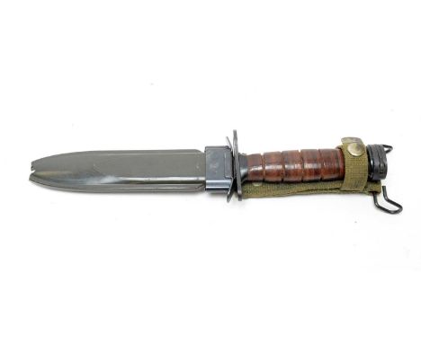 A Second World War US M4 combat knife/bayonet, the 16.5cms blade on leather grip and fitted an M8A1 scabbard. 