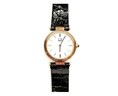 An Alfred Dunhill lady's gold-plated dress watch, with a white enamelled face, and baton markers. 