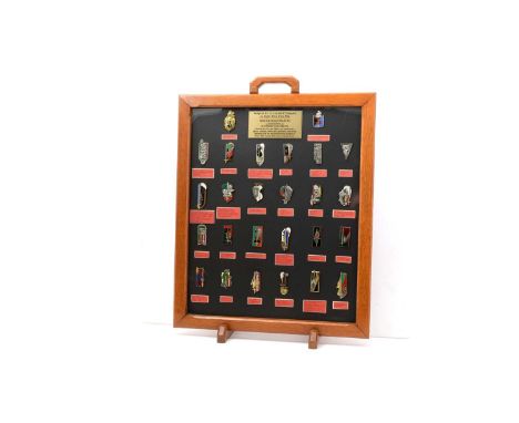 A collection of Insignes de la Legion E'trangere, the twenty-six enamelled metal promotion badges mounted above details of re