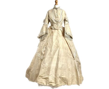 A Victorian four-piece champagne silk day dress, having button-down bodice with pagoda sleeves, full skirt, open-fronted over