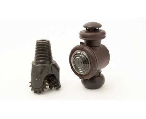 An oil drilling tricone drill bit, black painted, 18cms high; together with a carbide lamp, 22cms high. (2)