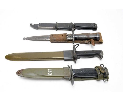 A Swedish M1896 pattern Mauser bayonet, with scabbard and leather frog; a US M8A1 bayonet, with scabbard; an AKM type II bayo