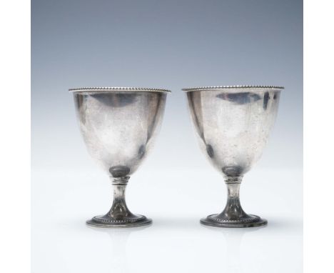 A pair of silver-plated egg cups featuring a classic beaded rim and pedestal base design. Each cup measures 2.5"H x 2" in dia