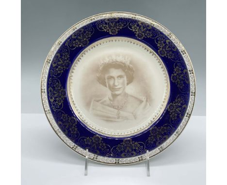 This porcelain plate was made to commemorate the coronation of Queen Elizabeth II in June 2, 1953. It features a white and in