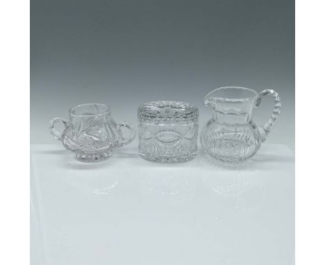 A three-piece set of cut crystal tableware featuring intricate designs. The set includes a small pitcher with a scalloped rim