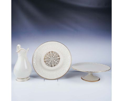 A refined collection of Lenox ivory porcelain tableware, featuring elegant gold trim and intricate embossed details. The set 