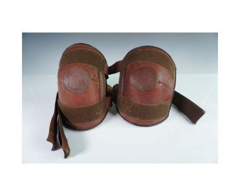 Pair of vintage leather knee pads marked Polo Equipment Merlo's Intl. Crafted with durable brown leather and suede-lined inte