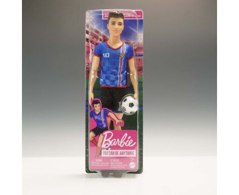 From the You Can Be Anything series, this boxed Ken doll represents a soccer player dressed in a blue jersey with team crest 
